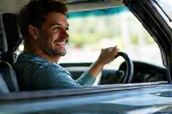 Happy customer driving shiny clean car